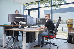 2 employees at computer workstations