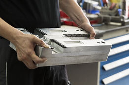 Employee is holding a tool